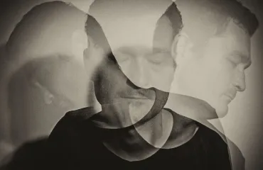 Black-and-white double exposure of a man's head seen from multiple angles, suggesting inner conflict or multiple selves.