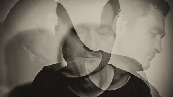 Black-and-white double exposure of a man's head seen from multiple angles, suggesting inner conflict or multiple selves.